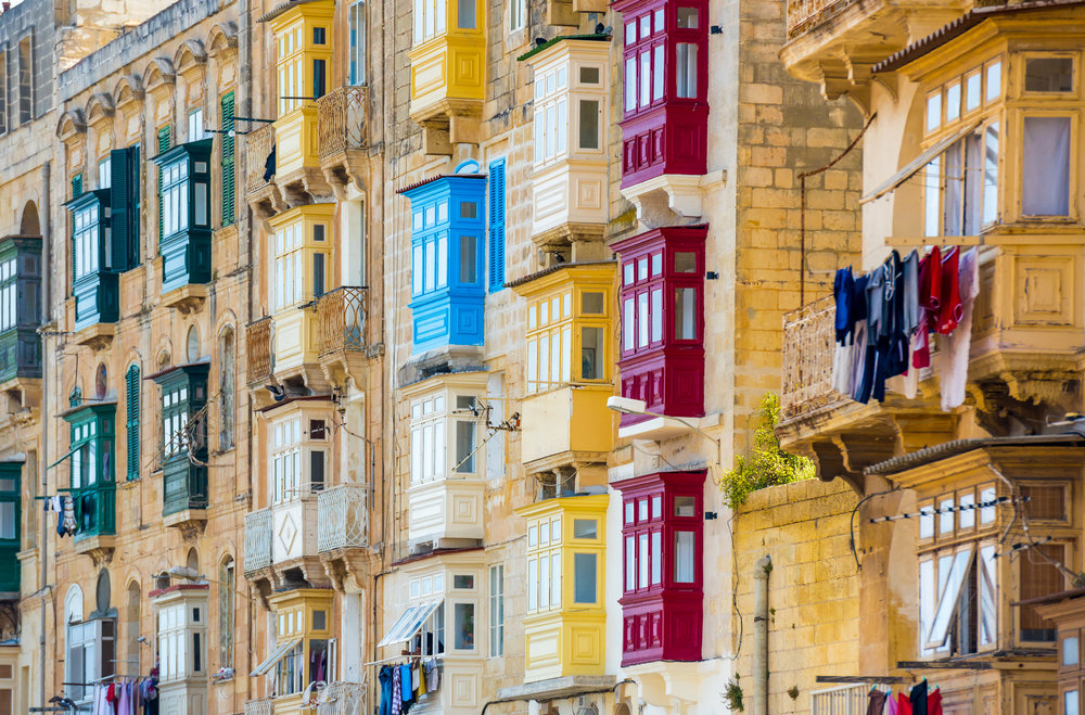 a motley of balconies on the facades of a street in Valletta